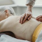 Starsza kobieta podczas relaksującego masażu pleców w gabinecie spa